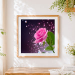 Finished pink rose with sparkling bubbles cross stitch artwork displayed