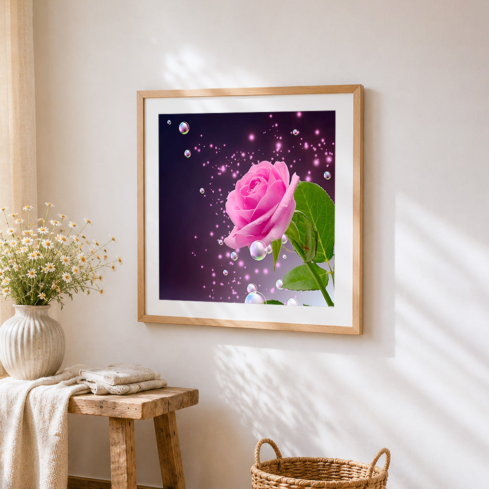 Pink rose with sparkling bubbles cross stitch artwork displayed on wall as home decor