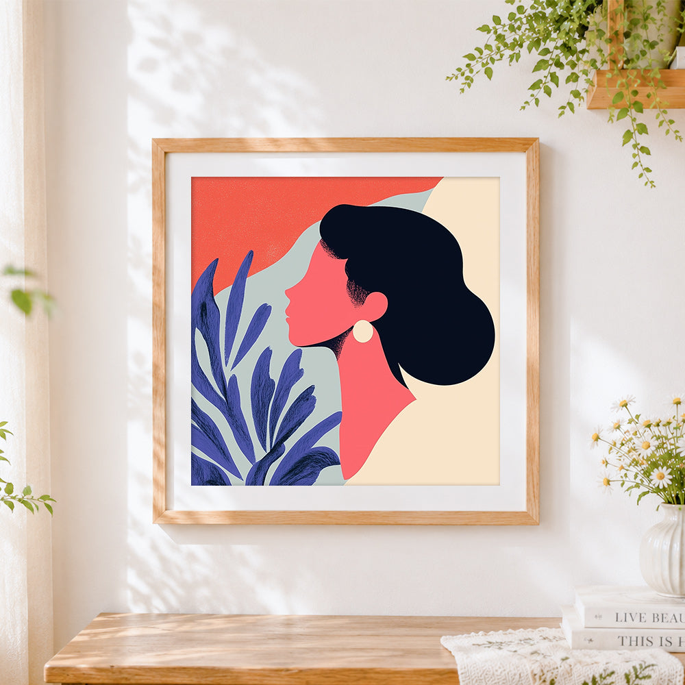 Finished pink silhouette and blue botanicals cross stitch artwork displayed