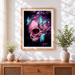 Finished pink skull with blue butterflies cross stitch artwork displayed