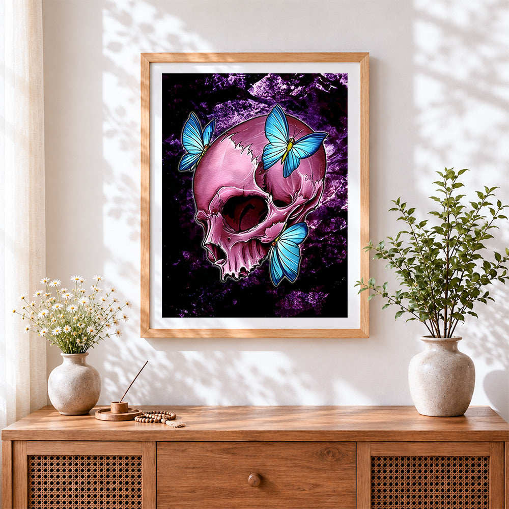 Finished pink skull with blue butterflies cross stitch artwork displayed