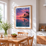 Pink sunset lagoon and palm trees cross stitch artwork displayed on wall as home decor
