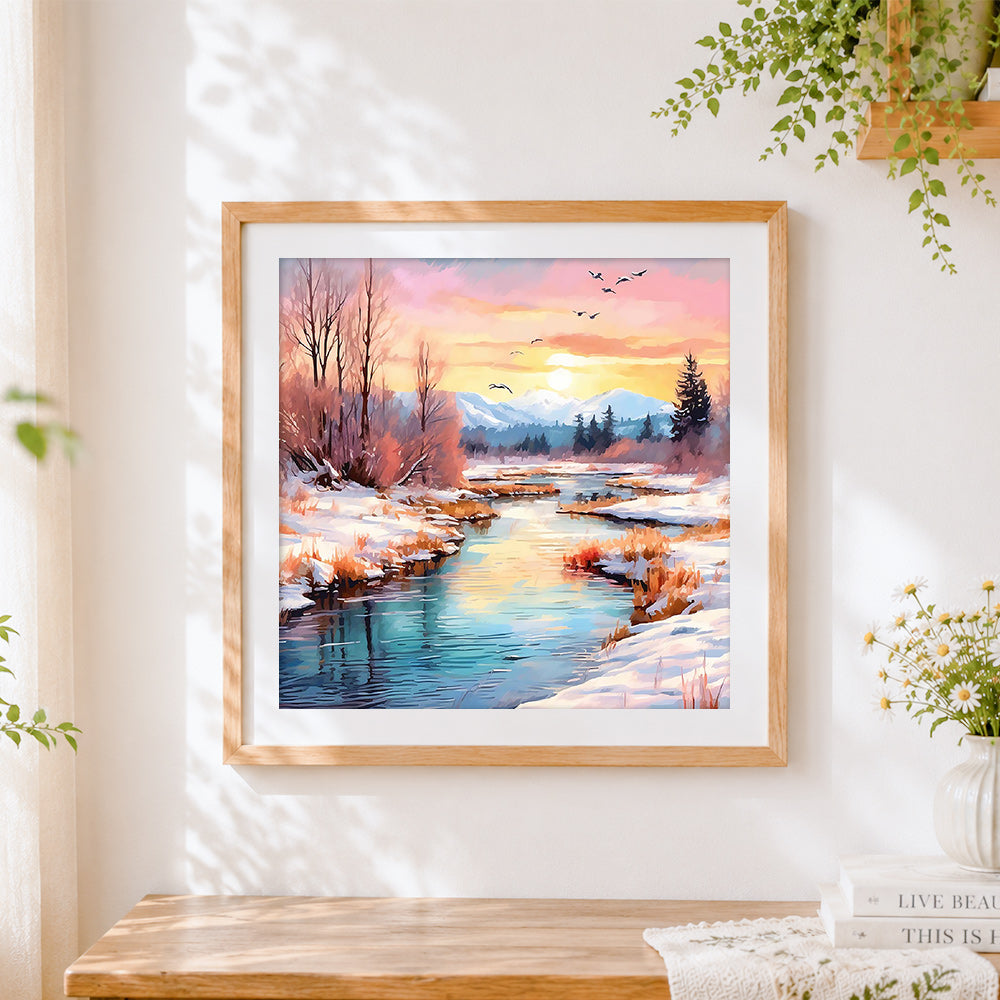 Finished pink sunset over a snowy river cross stitch artwork displayed
