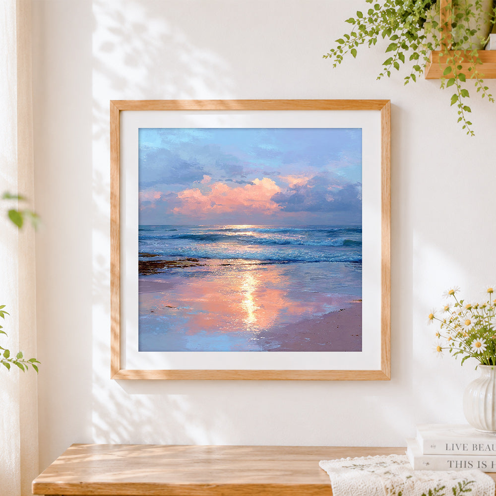 Finished pink sunset over ocean waves cross stitch artwork displayed