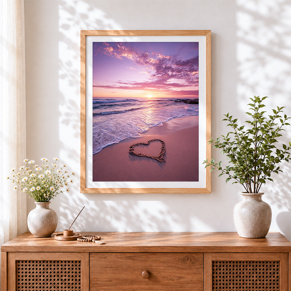 Finished pink sunset shoreline with sand heart cross stitch artwork displayed