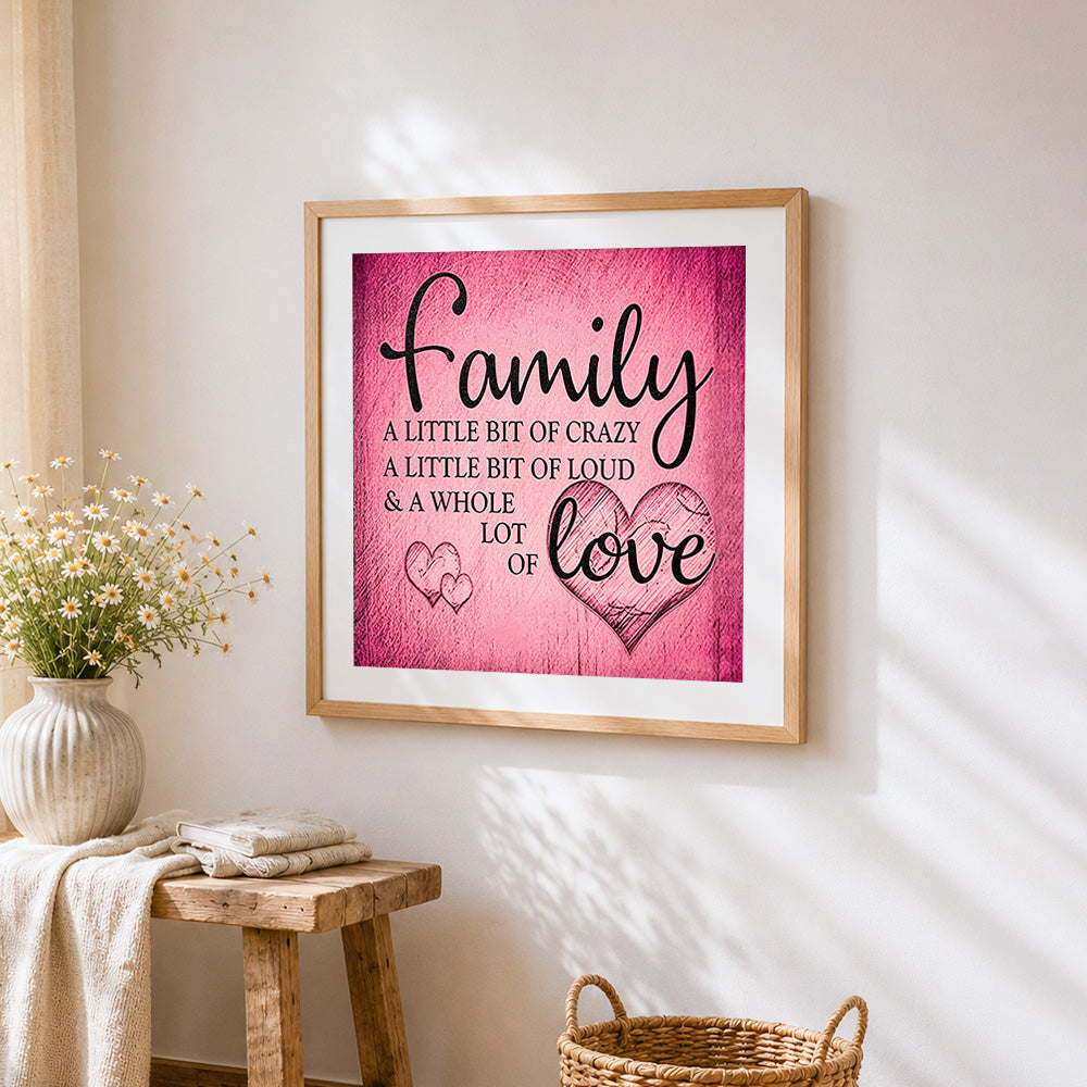 Pink texture family and love quote cross stitch artwork displayed on wall as home decor