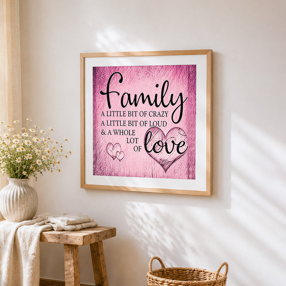Pink texture family quote cross stitch artwork displayed on wall as home decor