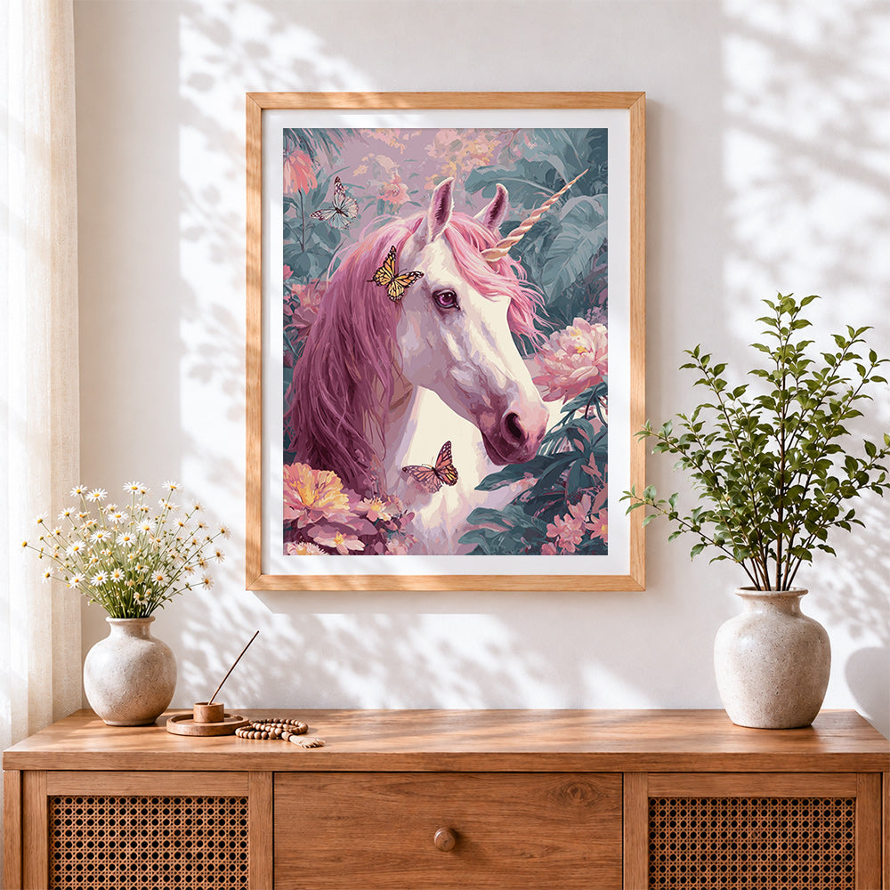 Finished pink unicorn in floral garden cross stitch artwork displayed