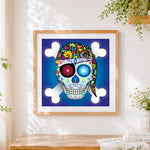 Finished pirate sugar skull and crossbones cross stitch artwork displayed