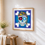 Pirate sugar skull and crossbones cross stitch artwork displayed on wall as home decor