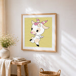 Playful baby goat cross stitch artwork displayed on wall as home decor