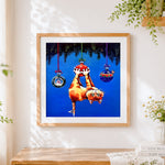Finished playful cat hanging from christmas baubles cross stitch artwork displayed