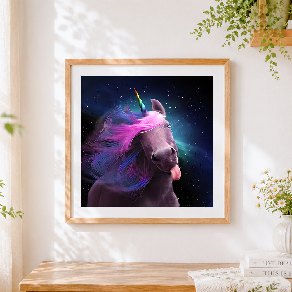 Finished playful cosmic unicorn with rainbow mane cross stitch artwork displayed