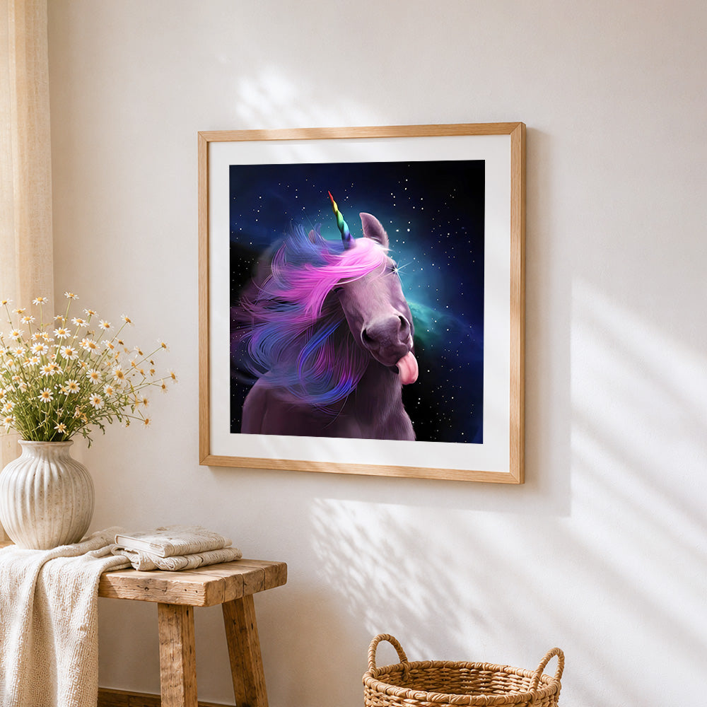 Playful cosmic unicorn with rainbow mane cross stitch artwork displayed on wall as home decor
