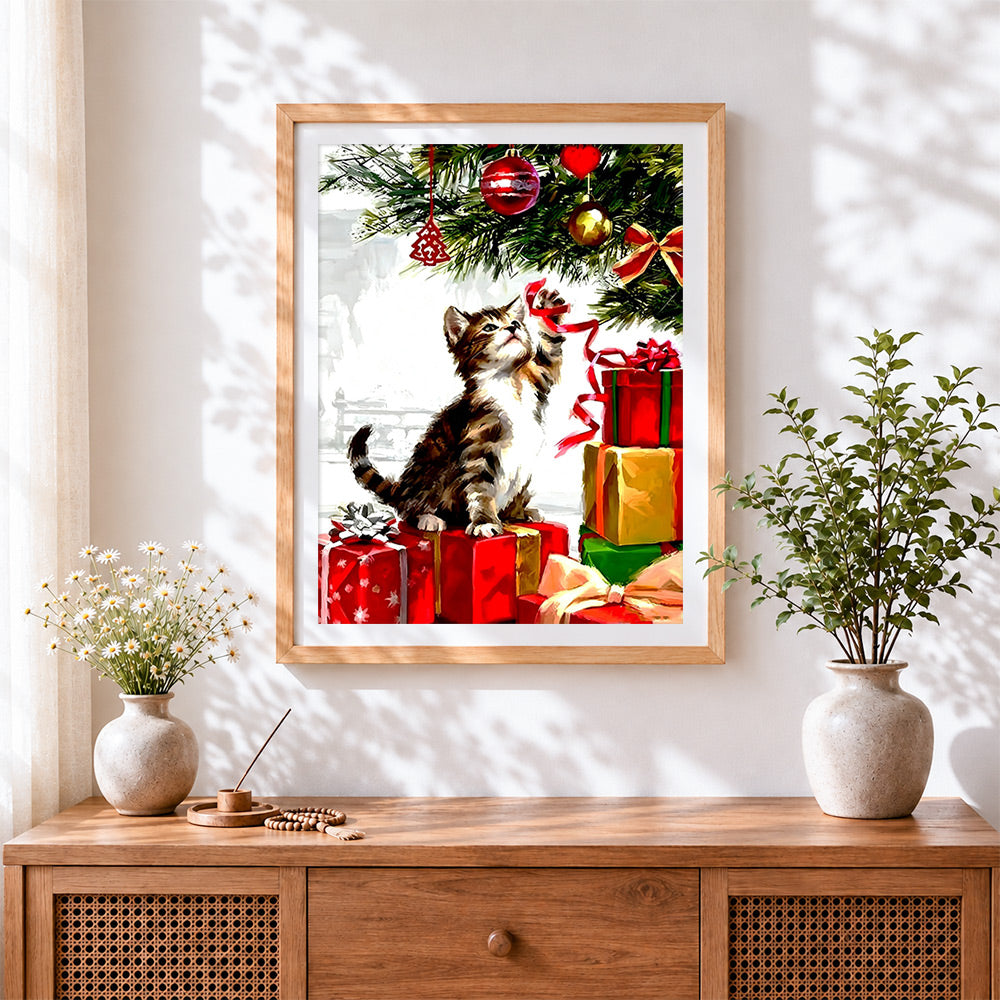 Finished playful kitten and christmas presents cross stitch artwork displayed