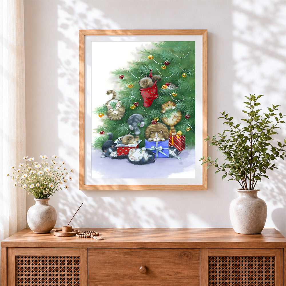 Finished playful kittens hiding in a christmas tree cross stitch artwork displayed