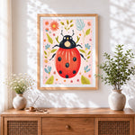 Finished playful ladybird on pink background cross stitch artwork displayed