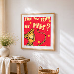 Playful leopard "can you find my eyes?" cross stitch artwork displayed on wall as home decor