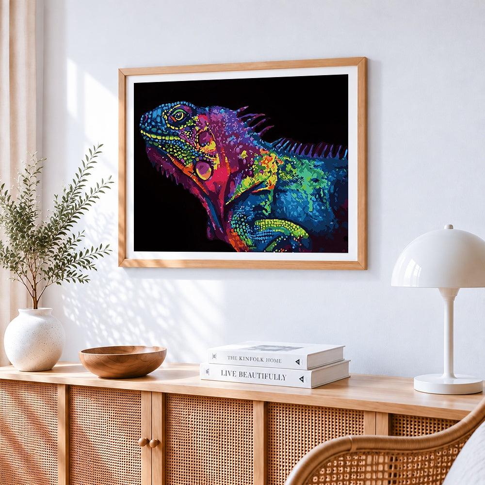Pop art style iguana head cross stitch artwork displayed on wall as home decor