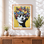 Finished pop art woman with butterfly crown cross stitch artwork displayed