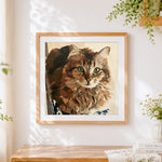 Finished portrait of a brown tabby cat cross stitch artwork displayed