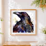 Finished portrait of a raven cross stitch artwork displayed