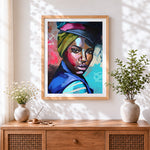 Finished portrait of a woman with headwrap cross stitch artwork displayed