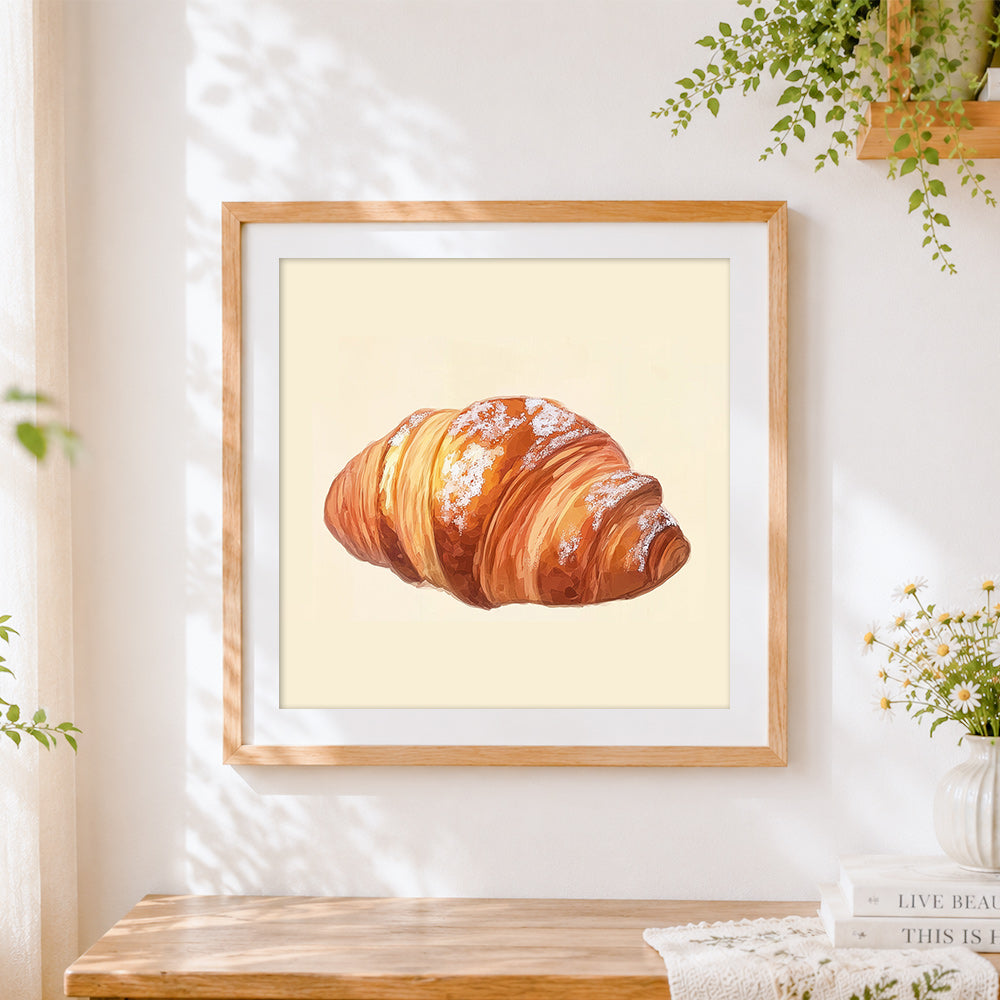 Finished powdered sugar croissant cross stitch artwork displayed