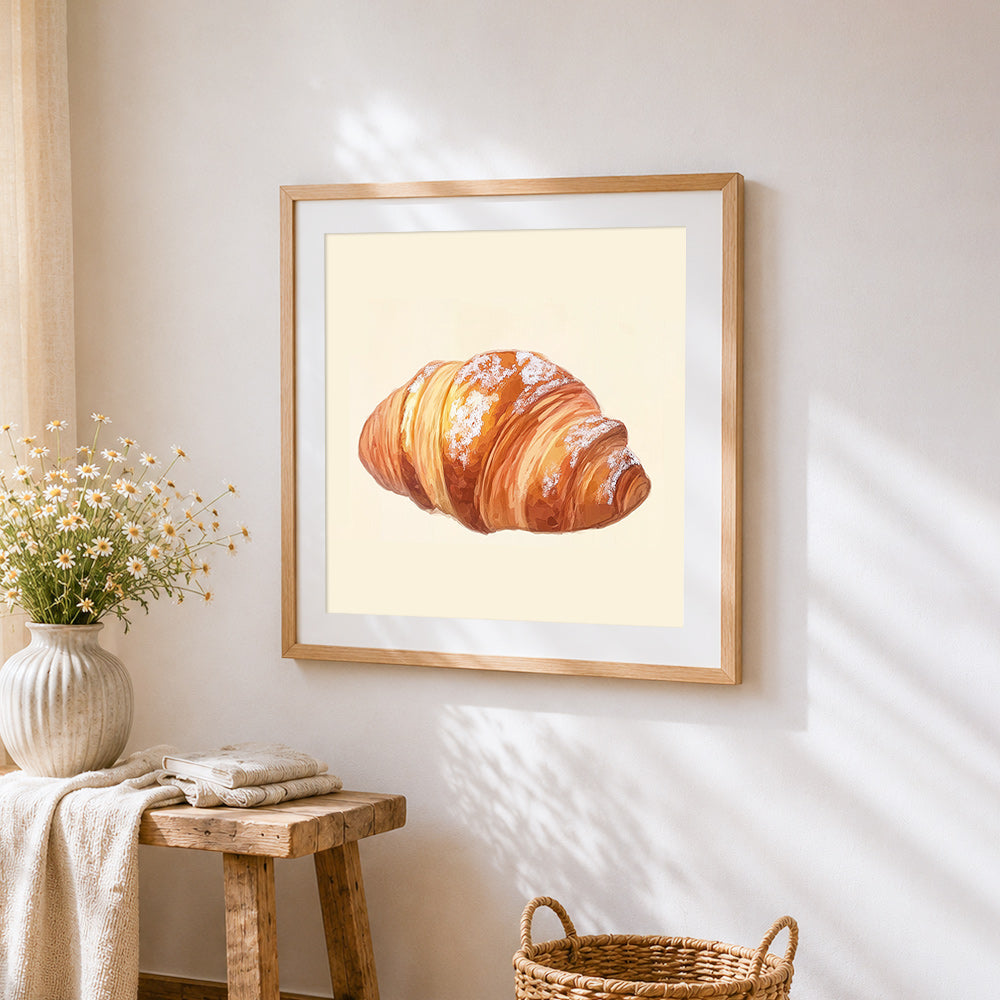 Powdered sugar croissant cross stitch artwork displayed on wall as home decor