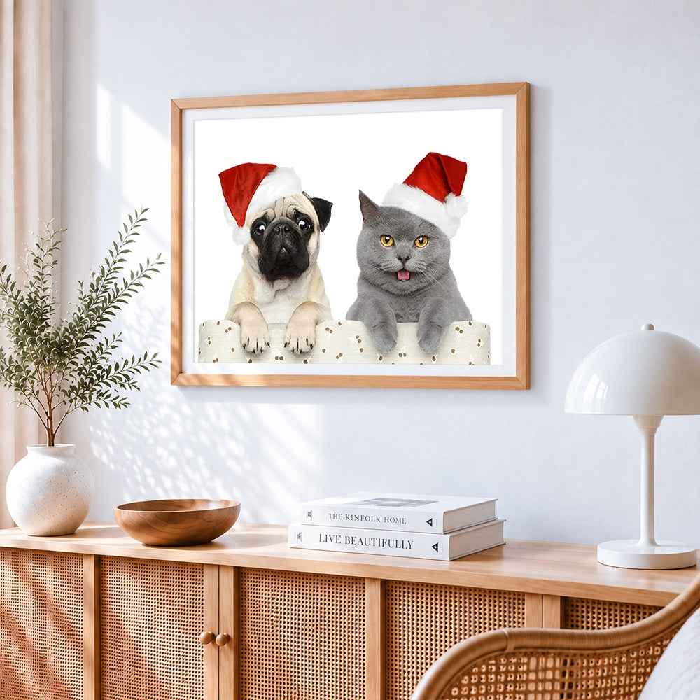 Pug and grey cat in santa hats cross stitch artwork displayed on wall as home decor
