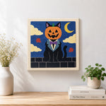 Finished pumpkin‑headed black cat artwork displayed on a wall