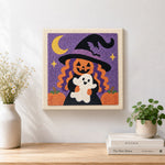 Finished pumpkin witch holding little ghost artwork displayed on a wall