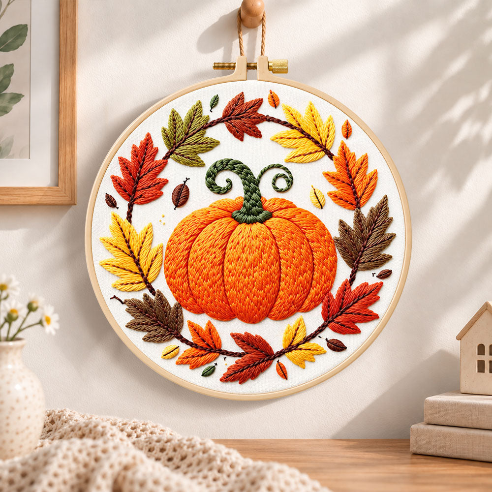 Pumpkin wreath with fall foliage embroidery hoop wall art displayed as warm and cosy handmade home decor