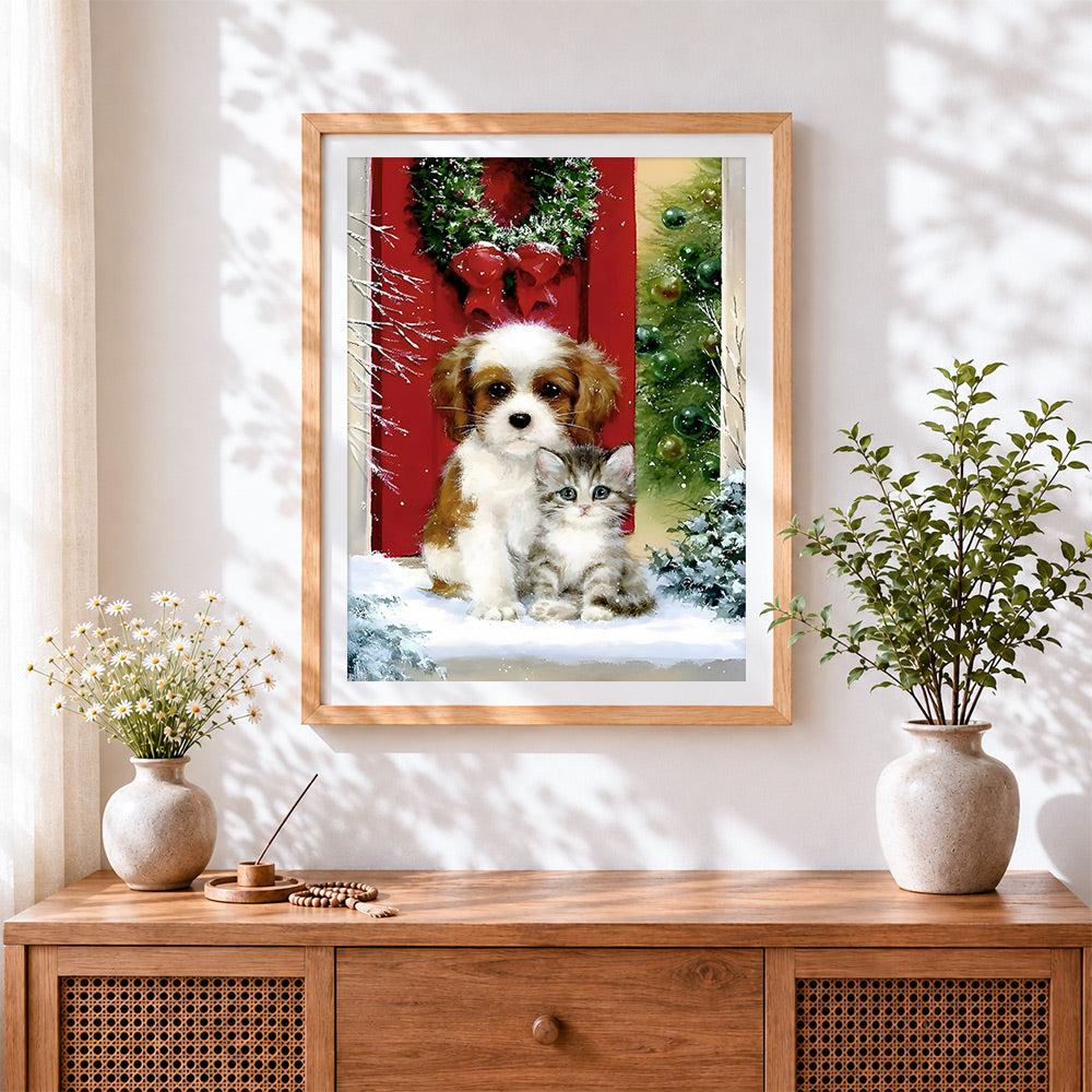 Finished puppy and kitten by a red door with christmas wreath cross stitch artwork displayed