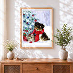 Finished puppy and kitten by a snowy christmas tree cross stitch artwork displayed