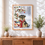 Finished puppy in red scarf by a snowy christmas tree cross stitch artwork displayed