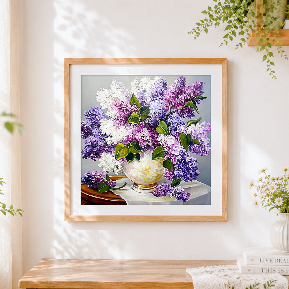Finished purple and white lilacs still life cross stitch artwork displayed