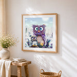Purple fantasy owl and baby cross stitch artwork displayed on wall as home decor