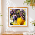 Finished purple irises and lemons cross stitch artwork displayed
