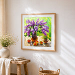 Purple lilacs and apples still life cross stitch artwork displayed on wall as home decor