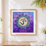Finished purple om symbol mandala cross stitch artwork displayed