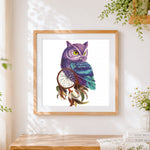 Finished purple owl with dreamcatcher cross stitch artwork displayed