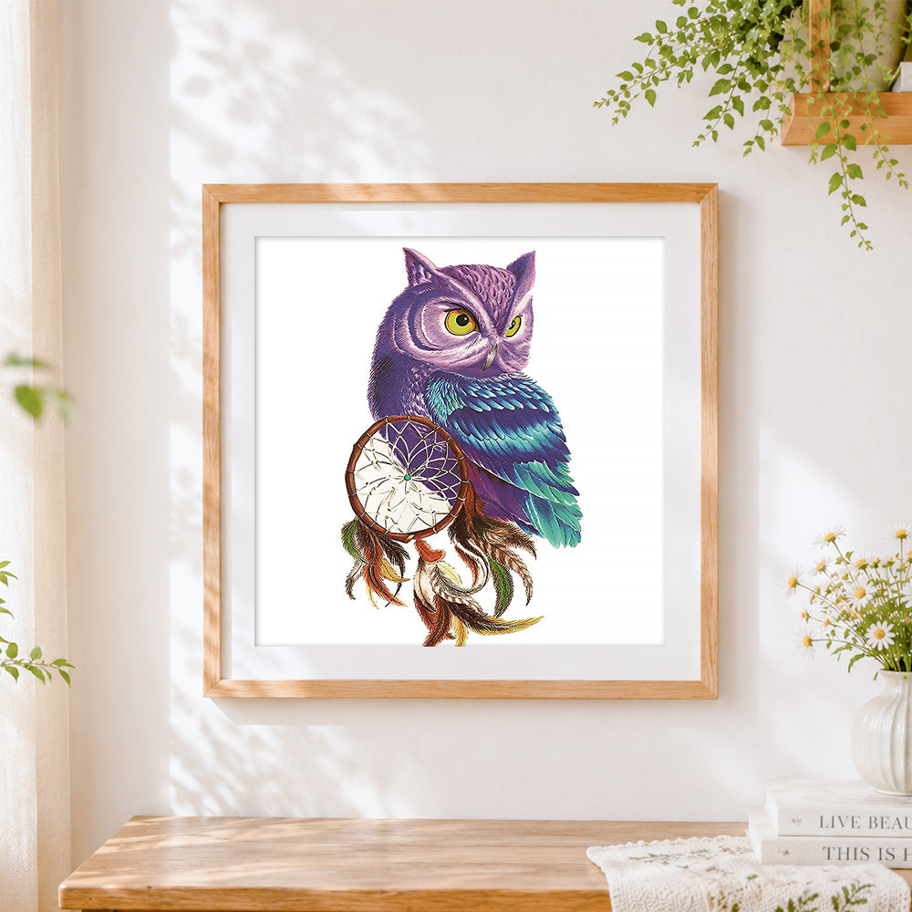 Finished purple owl with dreamcatcher cross stitch artwork displayed