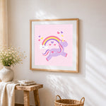 Purple unicorn jumping over a rainbow cross stitch artwork displayed on wall as home decor