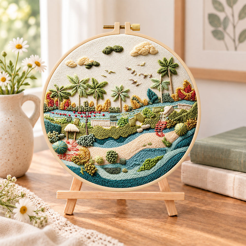 Quiet riverside tropics embroidery kit finished hoop displayed on a wooden stand as cosy tabletop decor