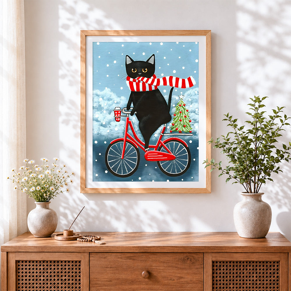 Finished quirky black cat on bicycle cross stitch artwork displayed