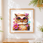 Finished quirky owl wearing pink glasses cross stitch artwork displayed