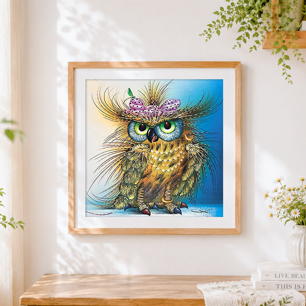 Finished quirky owl with butterfly and pearls cross stitch artwork displayed