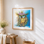 Quirky owl with butterfly and pearls cross stitch artwork displayed on wall as home decor
