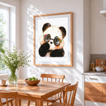 Quirky panda with glasses cross stitch artwork displayed on wall as home decor